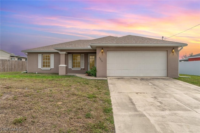 view of front of house featuring a lawn and a garage