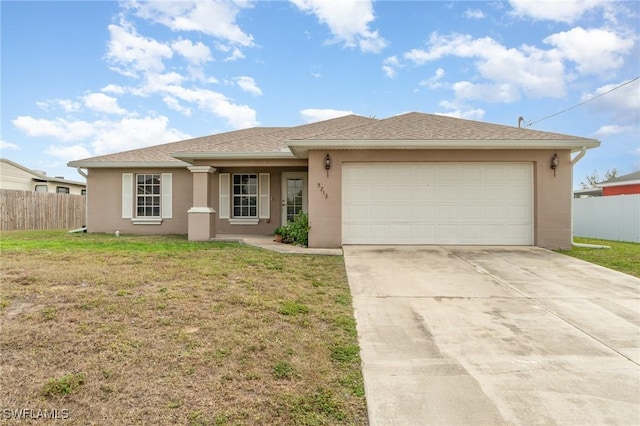 view of front of property with a garage and a front lawn