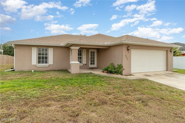 view of front of house with a front yard and a garage