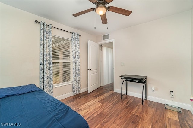 bedroom featuring ceiling fan and dark wood-type flooring