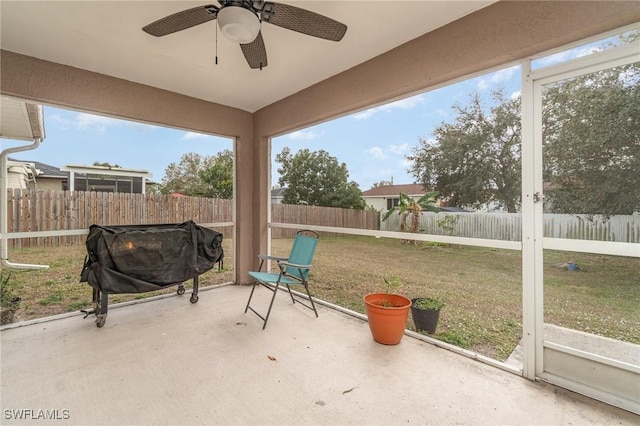 unfurnished sunroom featuring ceiling fan