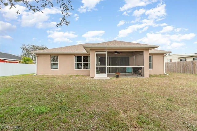 back of house with a lawn and a sunroom