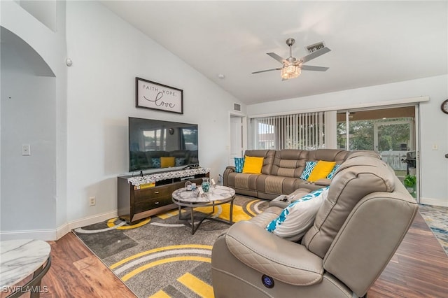 living room featuring hardwood / wood-style floors, vaulted ceiling, and ceiling fan