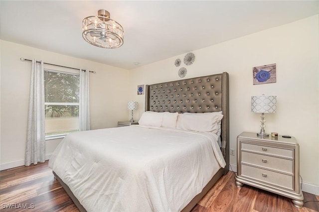 bedroom with dark hardwood / wood-style flooring