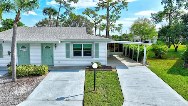 ranch-style house featuring a front yard and a carport