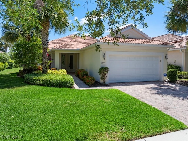 mediterranean / spanish-style house with a front lawn and a garage