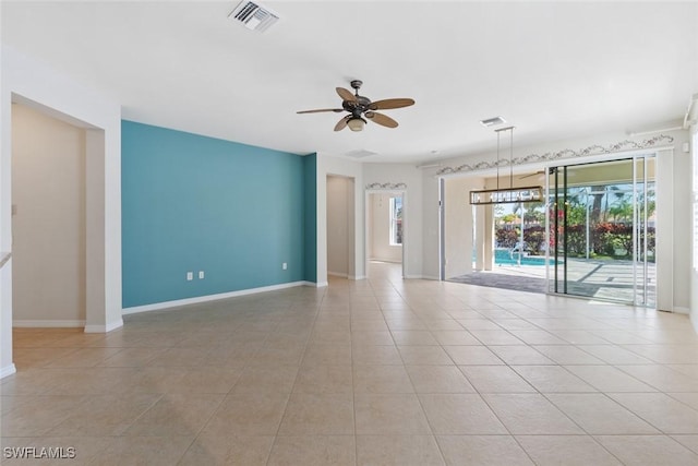 tiled spare room featuring ceiling fan