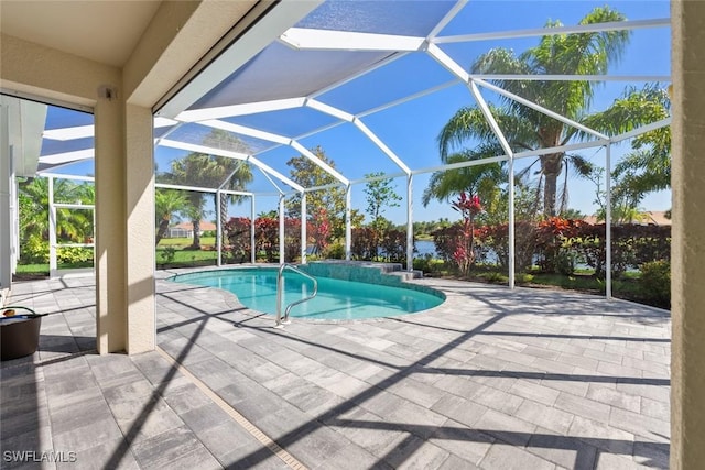 view of pool with a patio area and a lanai