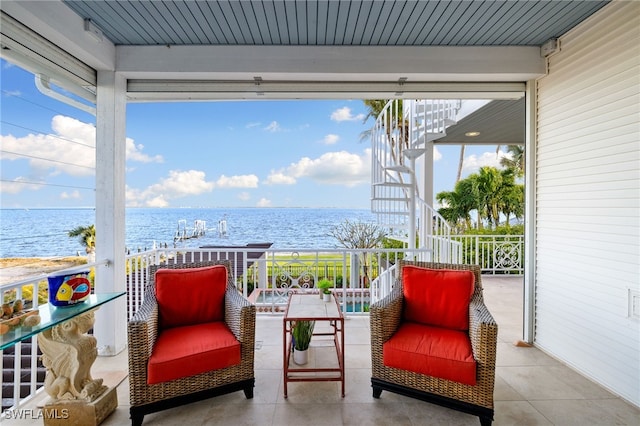 view of patio / terrace with a water view and a balcony