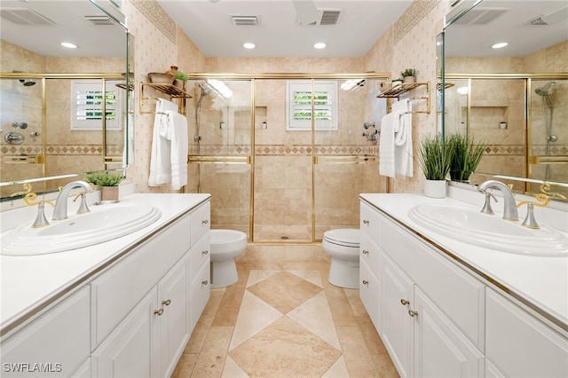 bathroom with a healthy amount of sunlight, toilet, and a shower with door