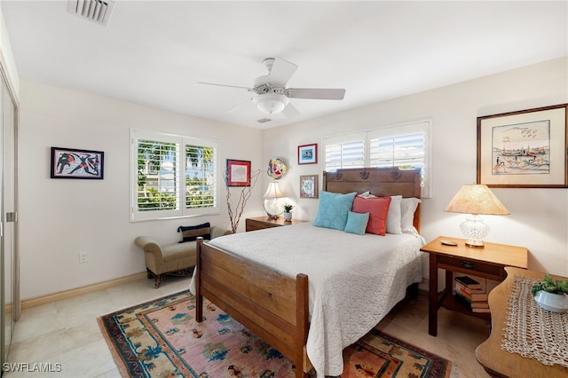 bedroom with multiple windows and ceiling fan