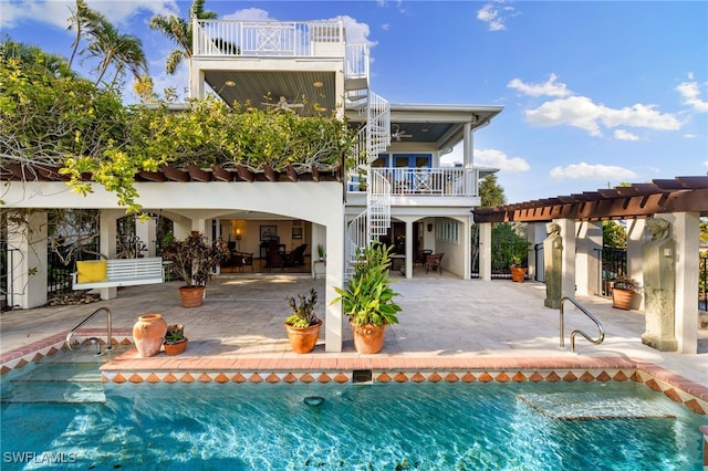 back of house featuring a pergola, a patio area, ceiling fan, and a balcony