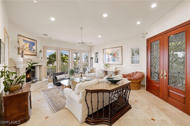 living room featuring ceiling fan, french doors, and a premium fireplace