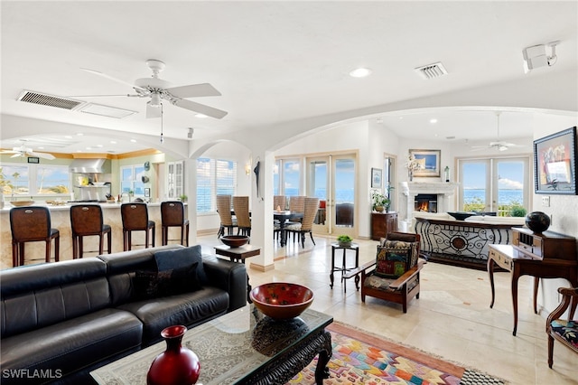 tiled living room featuring plenty of natural light and french doors