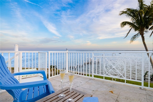 balcony with a water view and a beach view