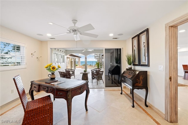 tiled dining space featuring ceiling fan and plenty of natural light