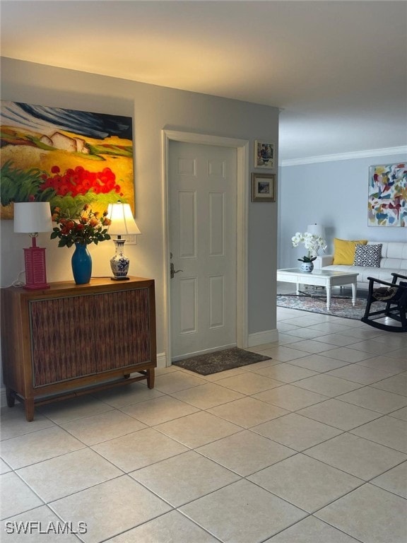 tiled foyer entrance with crown molding