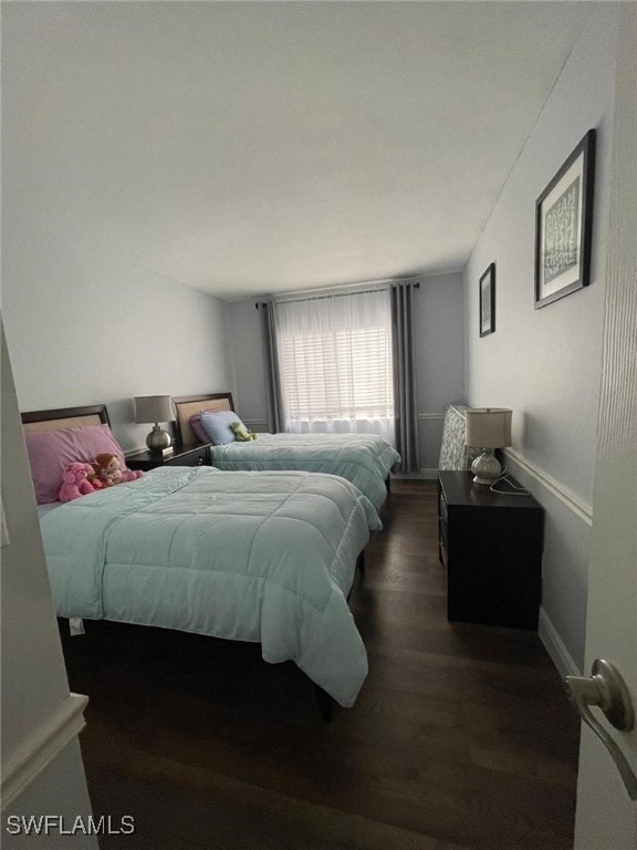 bedroom featuring dark wood-type flooring