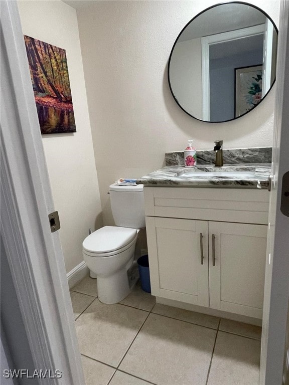 bathroom with tile patterned floors, vanity, and toilet