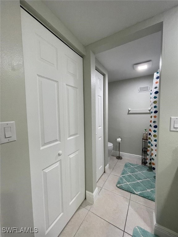 bathroom featuring tile patterned floors and toilet