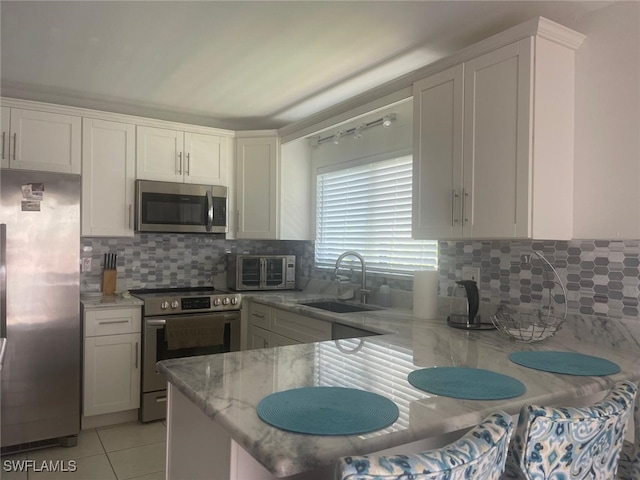 kitchen featuring sink, white cabinets, and stainless steel appliances