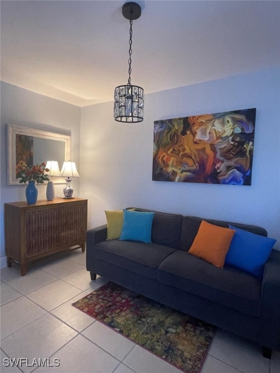 living room with light tile patterned floors and an inviting chandelier