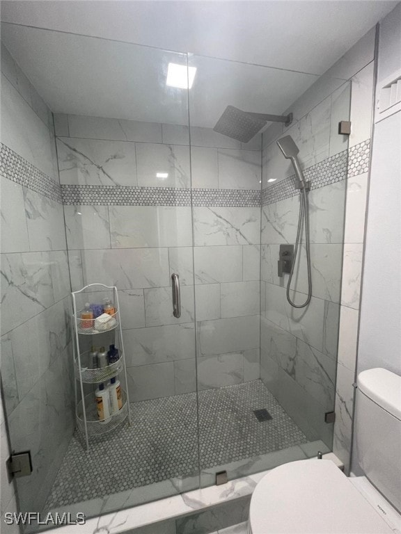 bathroom featuring an enclosed shower and toilet