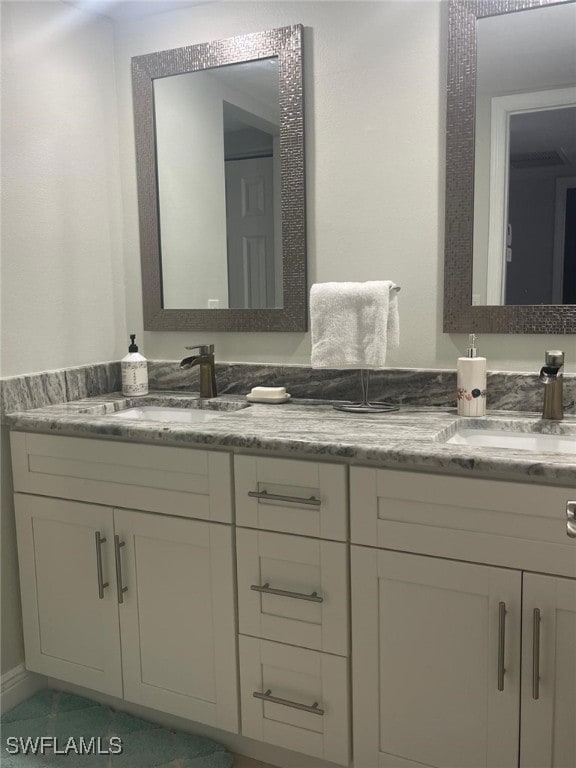 bathroom with tile patterned flooring and vanity