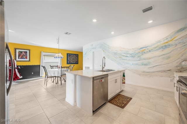 kitchen with sink, an island with sink, decorative light fixtures, white cabinetry, and stainless steel appliances