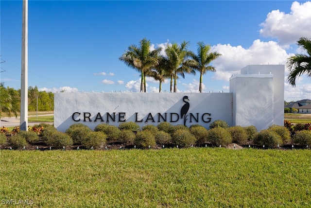 community / neighborhood sign with a lawn