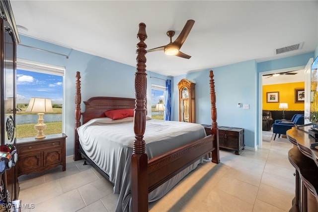 tiled bedroom with multiple windows and ceiling fan