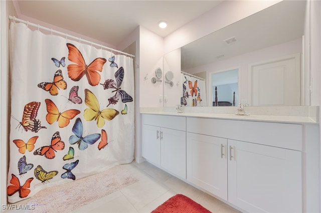 bathroom featuring tile patterned flooring and vanity