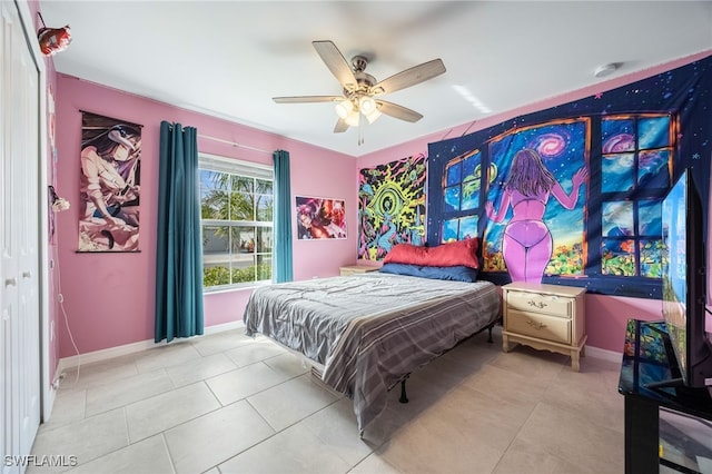 bedroom featuring ceiling fan, a closet, and light tile patterned floors