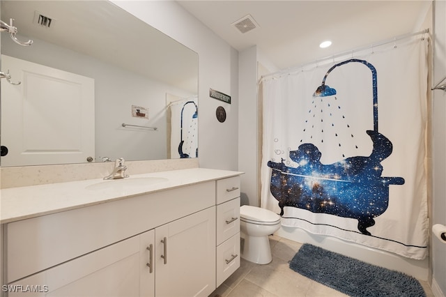 bathroom with tile patterned flooring, vanity, and toilet