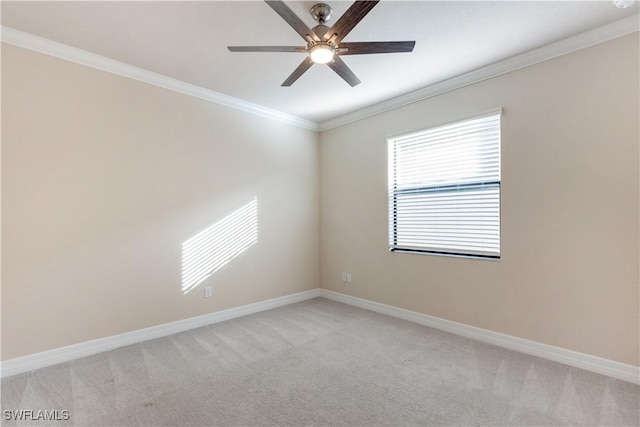 spare room with ceiling fan, ornamental molding, and light carpet