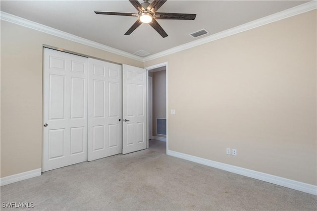 unfurnished bedroom with ceiling fan, ornamental molding, light carpet, and a closet