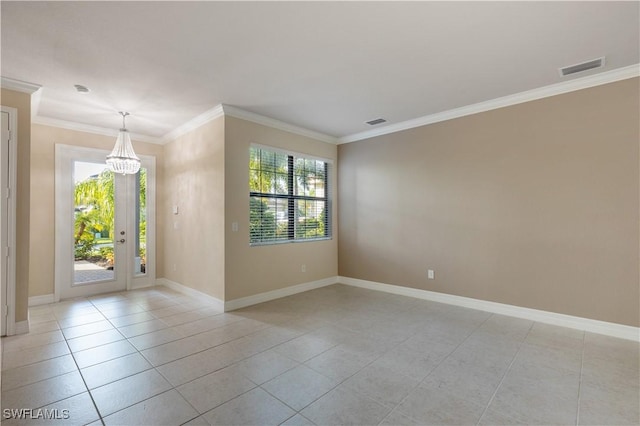 tiled empty room featuring crown molding and a chandelier