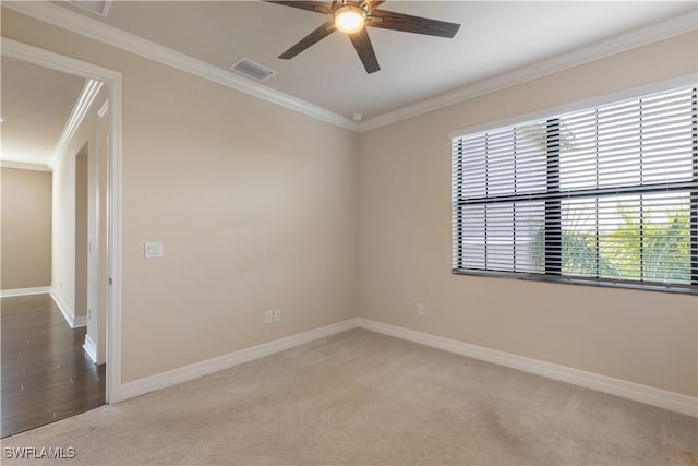 carpeted spare room featuring ceiling fan and ornamental molding