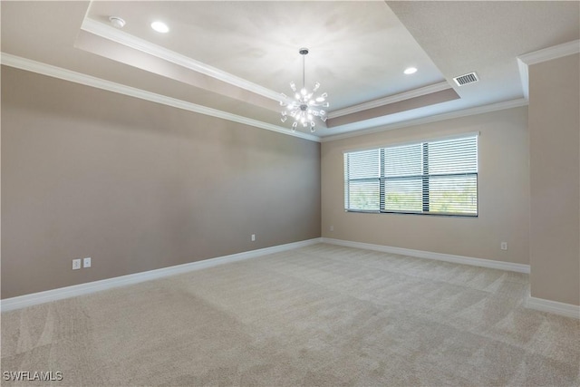 spare room with a raised ceiling, light colored carpet, crown molding, and an inviting chandelier