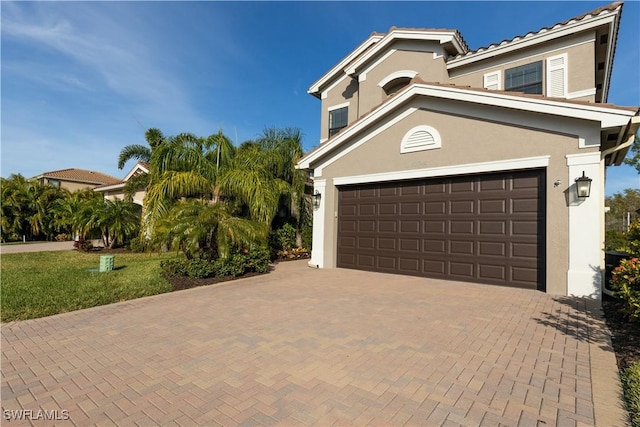 view of front facade with a front lawn and a garage