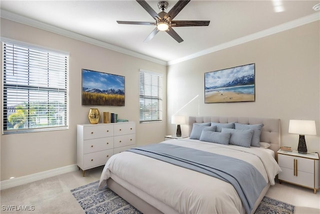 carpeted bedroom with multiple windows, ceiling fan, and ornamental molding