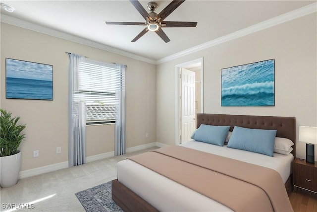 carpeted bedroom with ceiling fan and crown molding