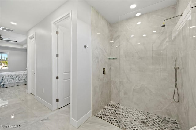 bathroom with ceiling fan and tiled shower