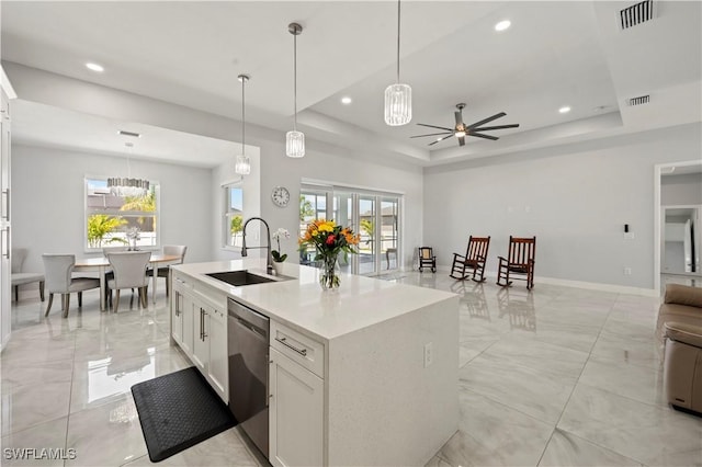 kitchen featuring dishwasher, a tray ceiling, white cabinets, and sink