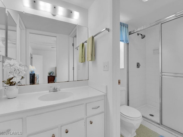 bathroom featuring vanity, toilet, and walk in shower