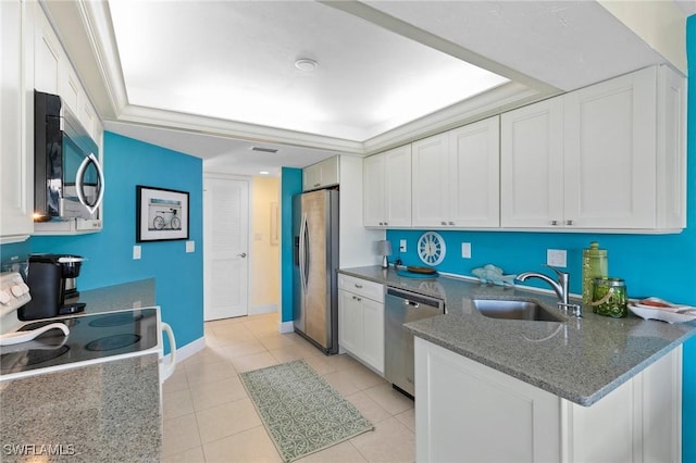 kitchen with white cabinetry, sink, dark stone counters, light tile patterned floors, and appliances with stainless steel finishes