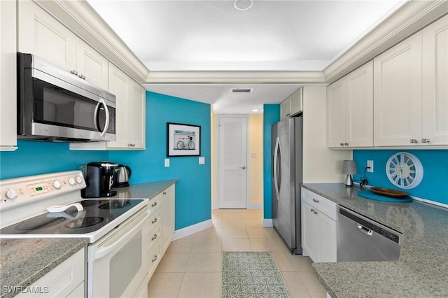 kitchen with white cabinets, stone countertops, light tile patterned flooring, and appliances with stainless steel finishes