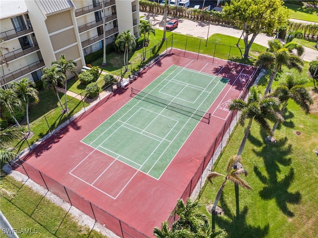 view of tennis court featuring basketball hoop