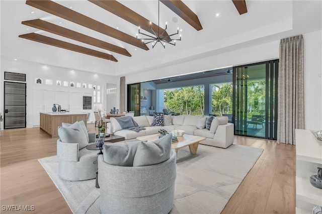 living room featuring light hardwood / wood-style floors, sink, and a chandelier