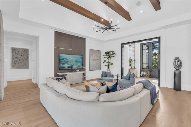 living room featuring light hardwood / wood-style floors, beam ceiling, and a chandelier